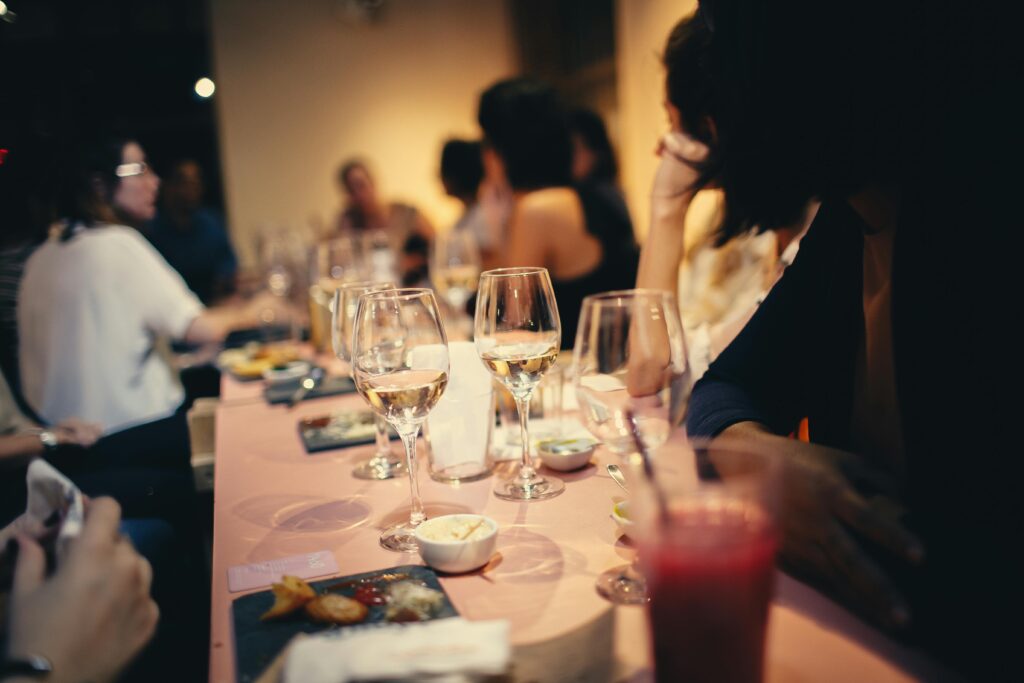 A lively indoor gathering with people enjoying drinks and conversation in a Brazilian restaurant.